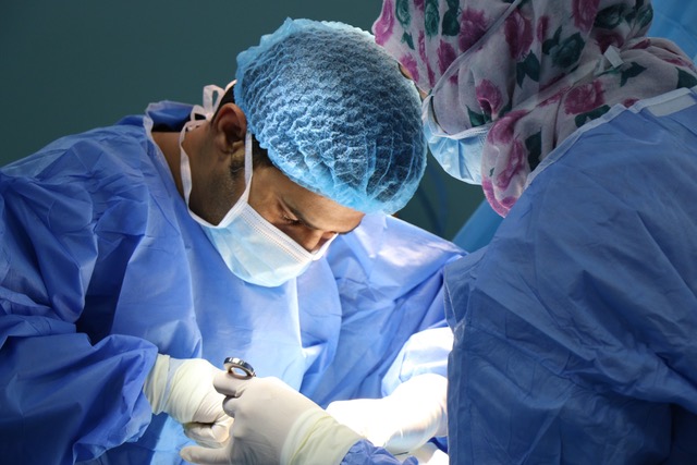 [complementing healthcare initiatives] image shows a surgeon performing an operation to illustrate the healthcare initiatives described in the article.