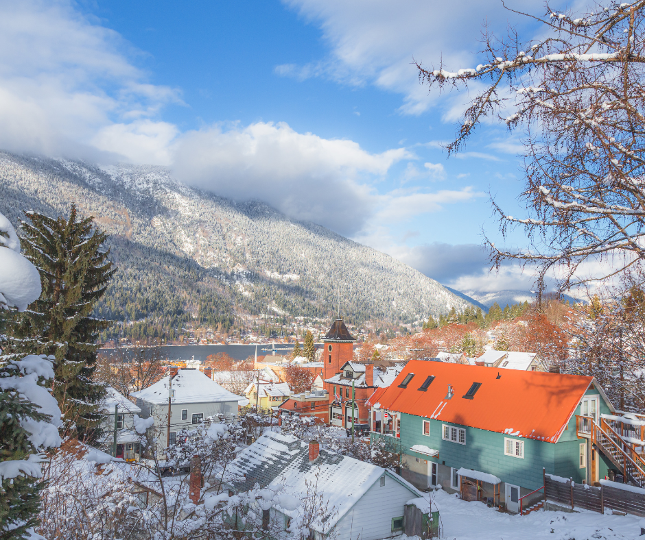 Winter in the BC town of Nelson. It's picturesque and pretty. Mountains are in the background, and the town is in the foreground.